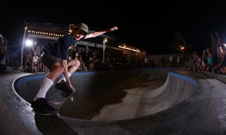 A skateboarder performs at the Pretty Poison bar and skate park – in front of a crowd of nighttime visitors – in Bali, Indonesia.